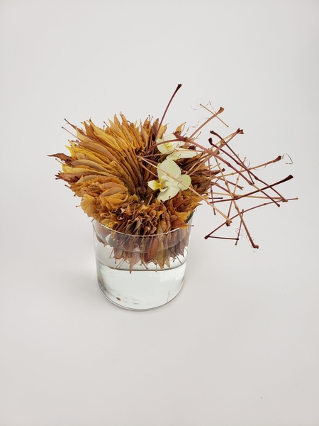 Thanksgiving table arrangement made from gathered fall leaves Thanksgiving table arrangement made from gathered fall leaves