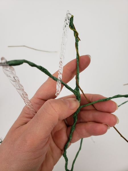 Bend both sides down and wind the longer stem around the tip of the stem to secure Bend both sides down and wind the longer stem around the tip of the stem to secure