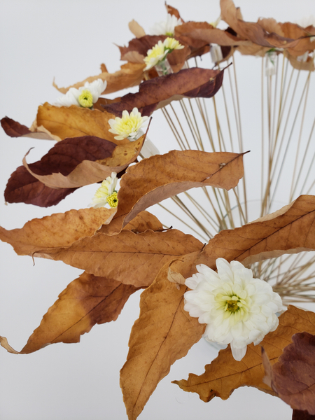 Creative way to display foraged autumn leaves in a floral design