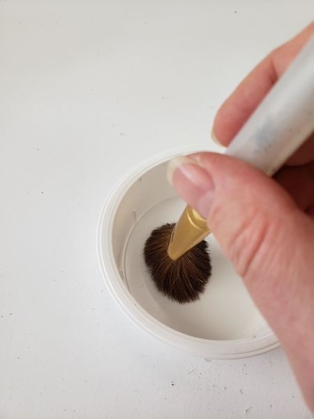 Dab the brush in a dry container to spread the paint Dab the brush in a dry container to spread the paint