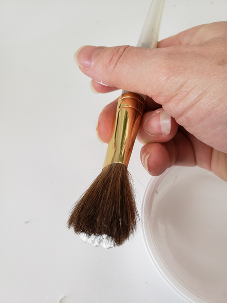 Dip a dry bristle brush in thick water based craft paint