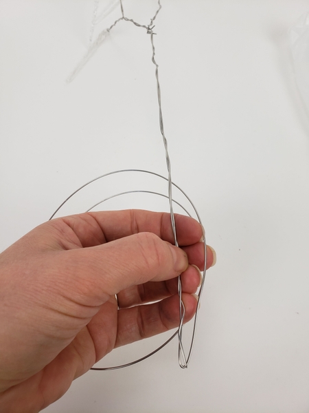Extend the new wire from the side stem down the branch and twist it together for a sturdy wire branch Extend the new wire from the side stem down the branch and twist it together for a sturdy wire branch
