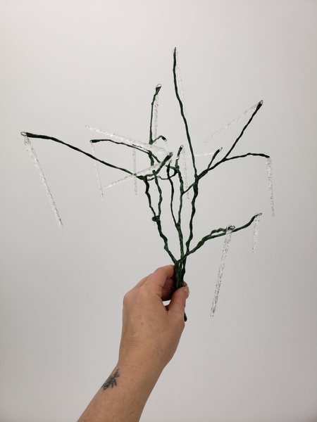 Lift the stems up and make sure they can carry the weight of the icicles before adding the plant material Lift the stems up and make sure they can carry the weight of the icicles before adding the plant material