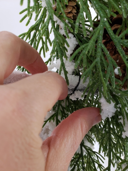 Make sure the wire is not visible by securing it behind the branches. Make sure the wire is not visible by securing it behind the branches.