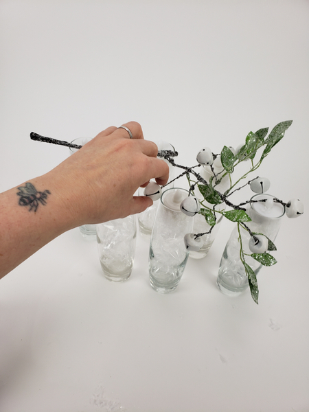 Measure the artificial branch against the vases you want to display the design on