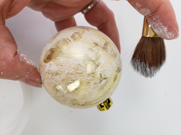 Paint the lightest dry brush strokes over the shiny bauble