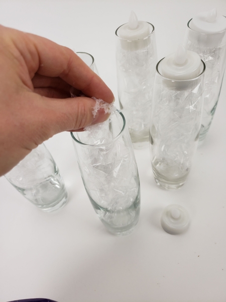 Remove the candle and fill the vase with artificial snow Remove the candle and fill the vase with artificial snow