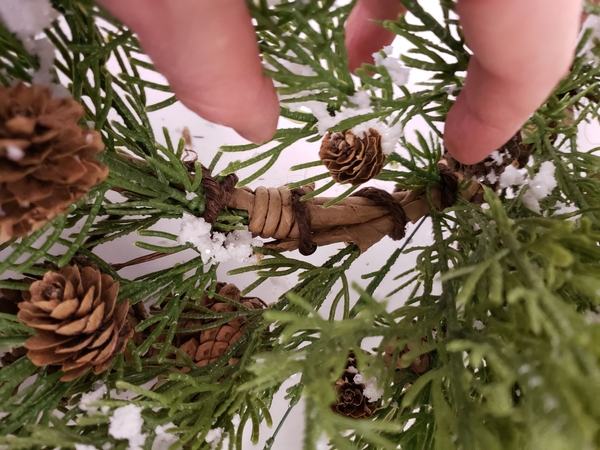 Re-position and wire the side branches of the wreath to give it better shape Re-position and wire the side branches of the wreath to give it better shape