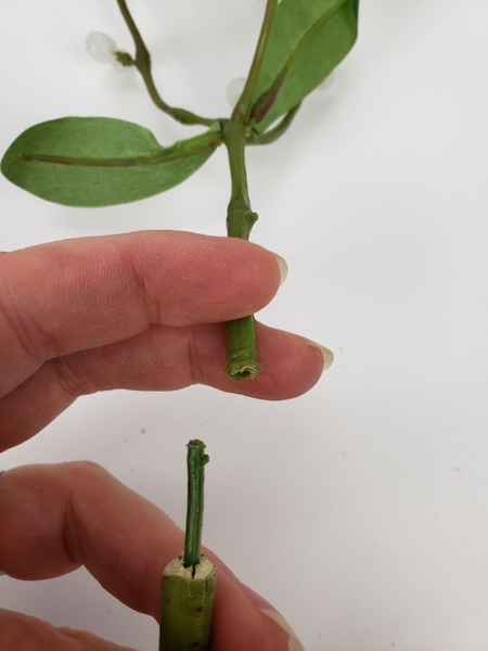 Slip the twig and the plastic stem over the wire to connect. Slip the twig and the plastic stem over the wire to connect.