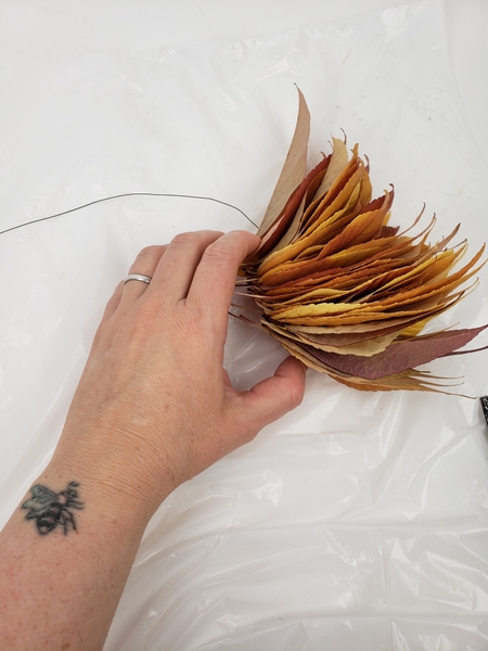 Thread a stack of autumn leaves with wire. Thread a stack of autumn leaves with wire.