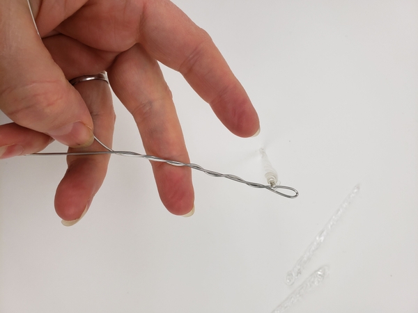 Twist the wire to secure the icicle Twist the wire to secure the icicle