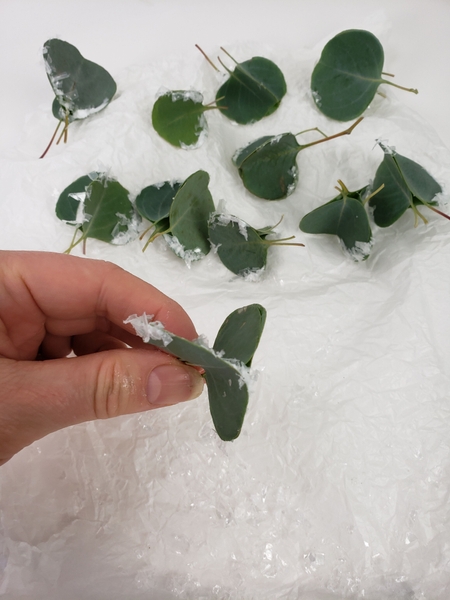 Add a dusting of artificial snow to the eucalyptus baubles Add a dusting of artificial snow to the eucalyptus baubles
