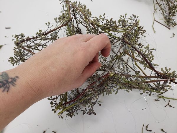 Add in the seeded eucalyptus and strap it in with the tinsel Add in the seeded eucalyptus and strap it in with the tinsel