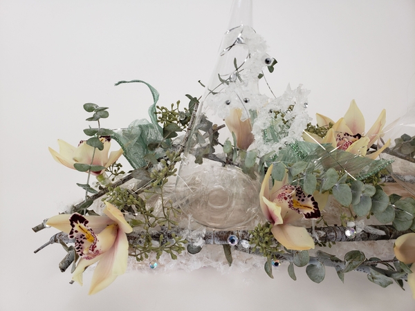 Adding fresh flowers in a dried floral design