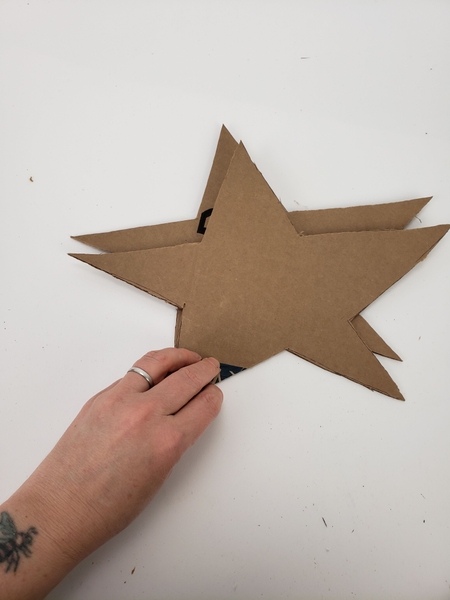 Cut out two cardboard star shapes Cut out two cardboard star shapes