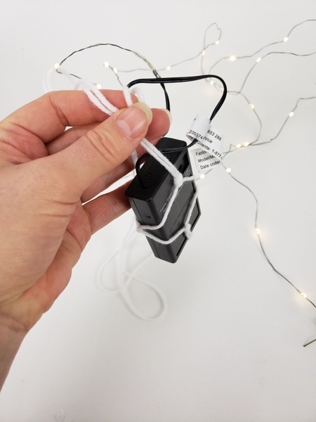 Hang the battery part of the fairy lights Hang the battery part of the fairy lights