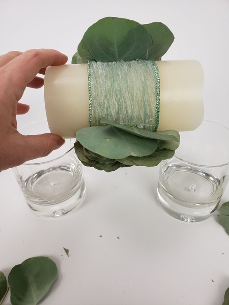 Place the candle at both ends on drinking glasses Place the candle at both ends on drinking glasses