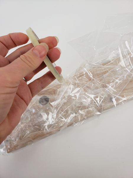 Secure the cellophane with clear tape Secure the cellophane with clear tape
