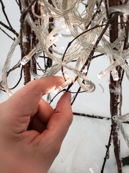 Then twirl the wire around the twig and position the light to rest on the twig like a firefly Then twirl the wire around the twig and position the light to rest on the twig like a firefly
