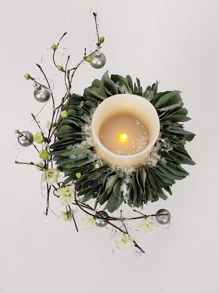 Use a battery powered candle for a long lasting Christmas floral display