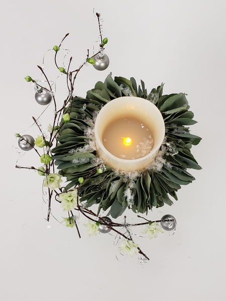 Use a battery powered candle for a long lasting Christmas floral display Use a battery powered candle for a long lasting Christmas floral display