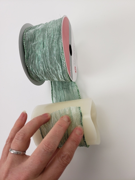 Wrap a battery powered candle with a single ring of ribbon Wrap a battery powered candle with a single ring of ribbon