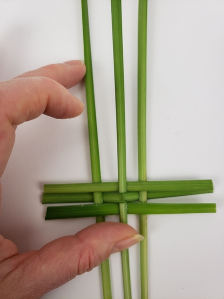 Place the grass on a flat working surface and weave the panel Place the grass on a flat working surface and weave the panel