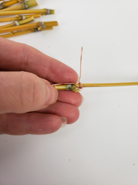 Wrap the wire around the bamboo below the node
