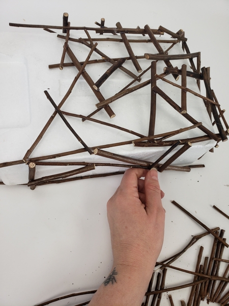 Again add less twigs as you glue them to the top part of the shape Again add less twigs as you glue them to the top part of the shape