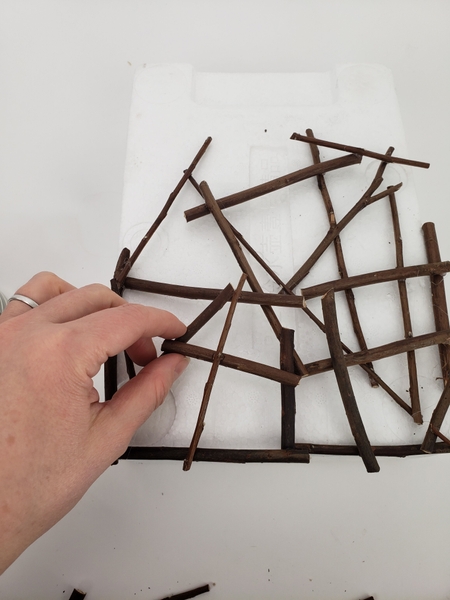 Glue more twigs to the one half of the shape and let it open up towards the other side Glue more twigs to the one half of the shape and let it open up towards the other side