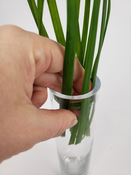 Push the circle back into the bud vase to keep the grass in place Push the circle back into the bud vase to keep the grass in place