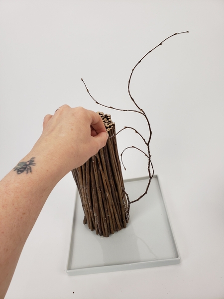 Slot the twig into the bundle so that it looks like it just grew that way Slot the twig into the bundle so that it looks like it just grew that way