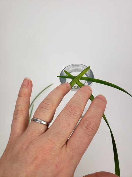 Start to add grass to radiate out from the vase Start to add grass to radiate out from the vase