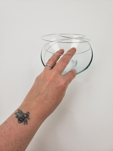 Cut a thin wire and bend it to spiral around a pretty glass container