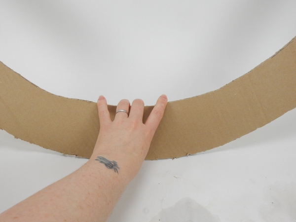 Cut out a huge sturdy cardboard doughnut shape Cut out a huge sturdy cardboard doughnut shape