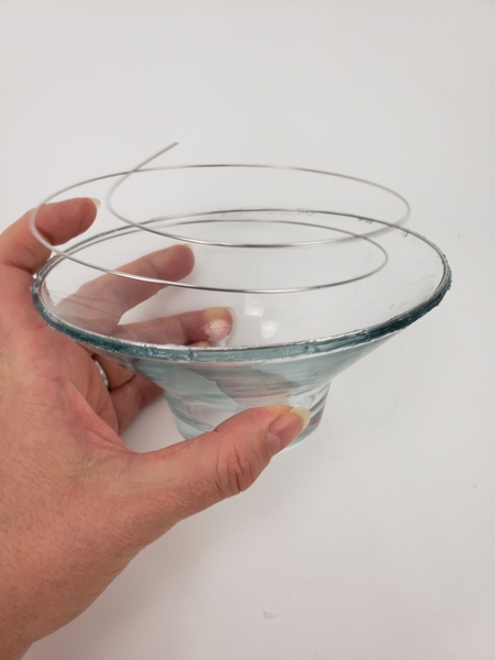 Slowly turn the container and glue the wire to the edge of the rim Slowly turn the container and glue the wire to the edge of the rim