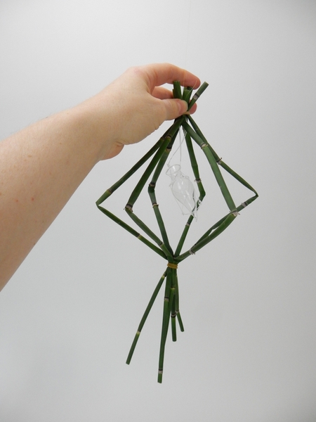 String up a glass seahorse vase to hang in the middle of the mobile. String up a glass seahorse vase to hang in the middle of the mobile.