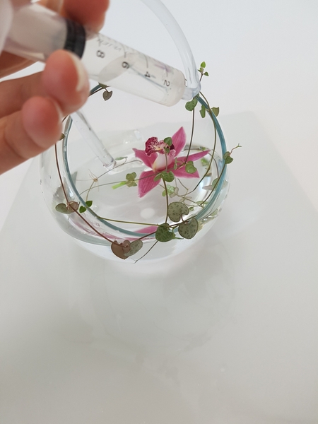 Top up the water in the vase to the very edge Top up the water in the vase to the very edge
