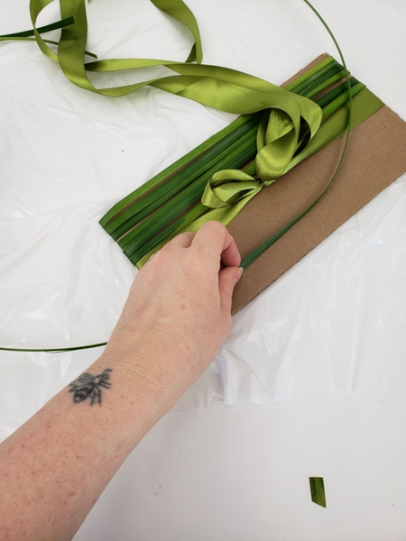 Add a band of grass below the ribbon to start to cover the lower half. Add a band of grass below the ribbon to start to cover the lower half.