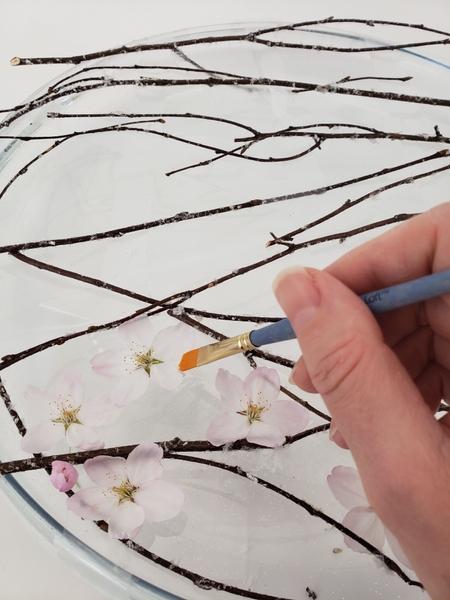Build up a still life by adding blossoms between the twigs Build up a still life by adding blossoms between the twigs