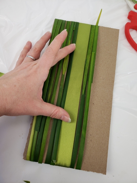 Keep the ribbon neat as you add the bands of grass Keep the ribbon neat as you add the bands of grass