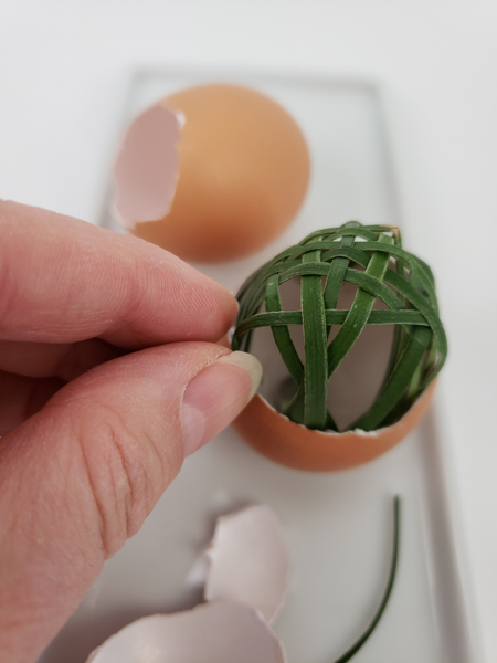 Make sure the grass ends are inside the egg