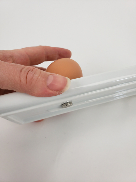 Slip another magnet below the egg to keep it securely in place