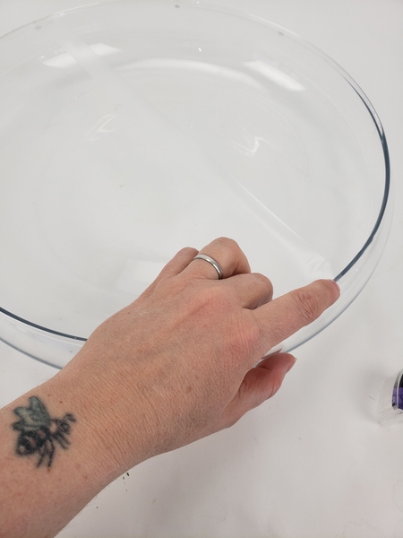 Stick down a grid of clear sticky tape over a shallow container Stick down a grid of clear sticky tape over a shallow container
