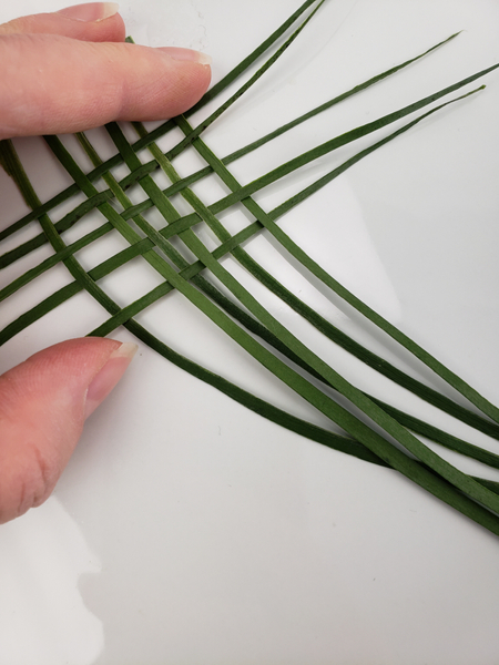 Weave a few blades of grass or palm to create a small basket weave