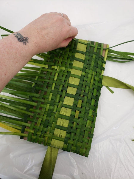 Weaving in strand after strand of grass Weaving in strand after strand of grass