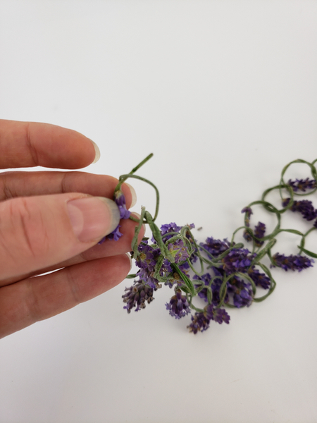By pressing the flower stem through both of the end lavender knots