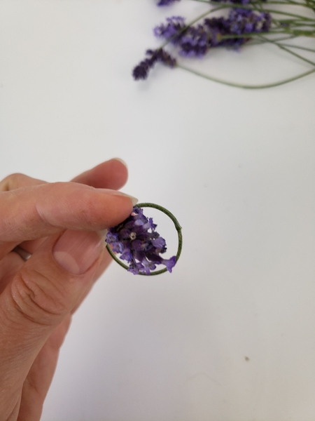Push the flower head through the circle to knot Push the flower head through the circle to knot