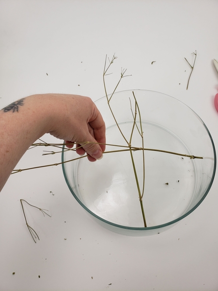 Add the second stem to cross over the first one. Add the second stem to cross over the first one.