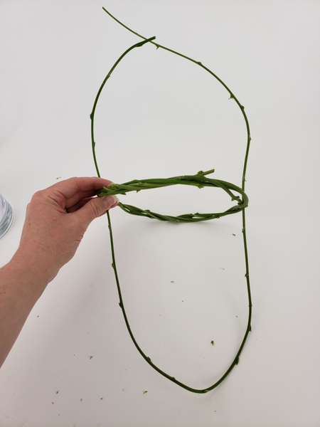 Loop it around under the wreath as if you are crafting a basket Loop it around under the wreath as if you are crafting a basket